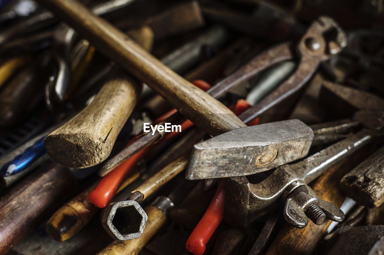 High angle view of various work tools on table in workshop