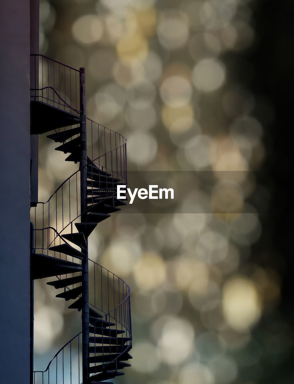 Low angle view of spiral staircase by building against sky