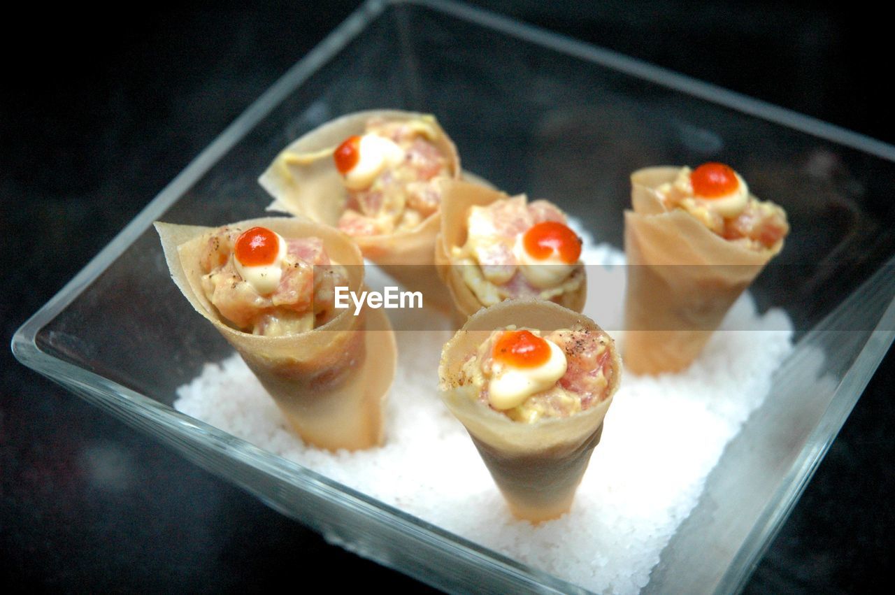 High angle view of ceviche in cones on plate