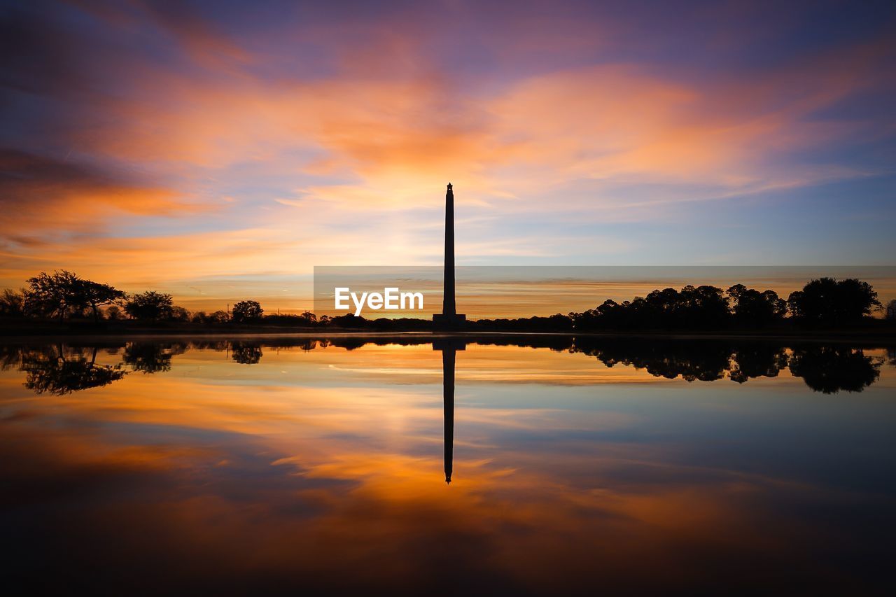 Scenic view of lake against orange sky