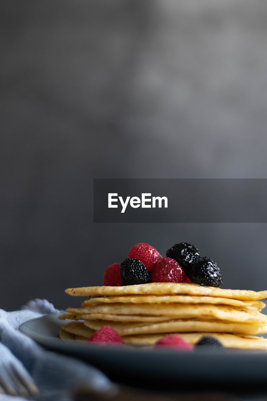 Homemade crepes on table, dark food photography, space for text