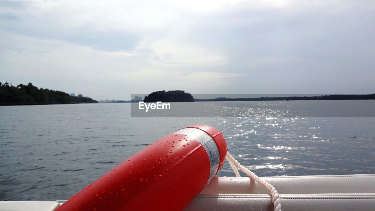 CLOSE-UP OF ROPE AGAINST SEA