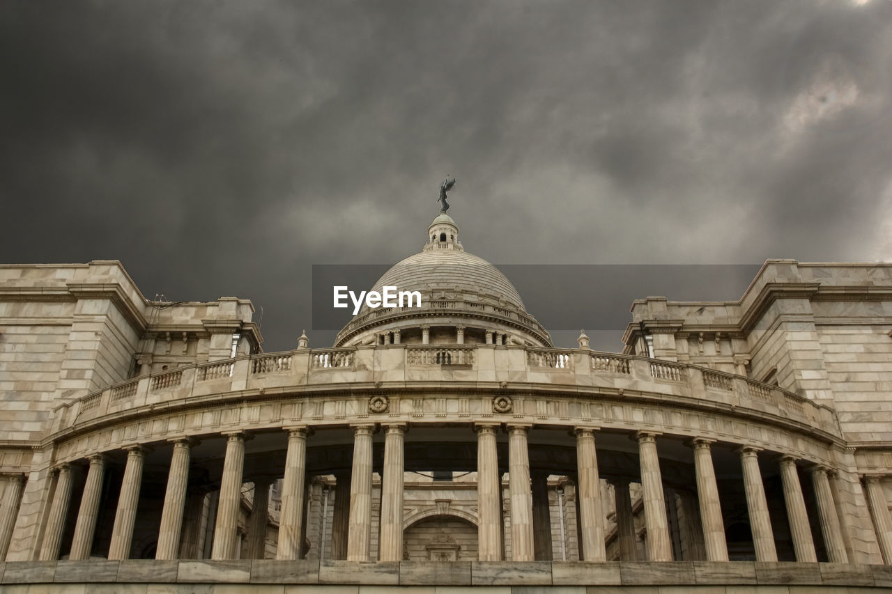 Low angle view of historical building against cloudy sky