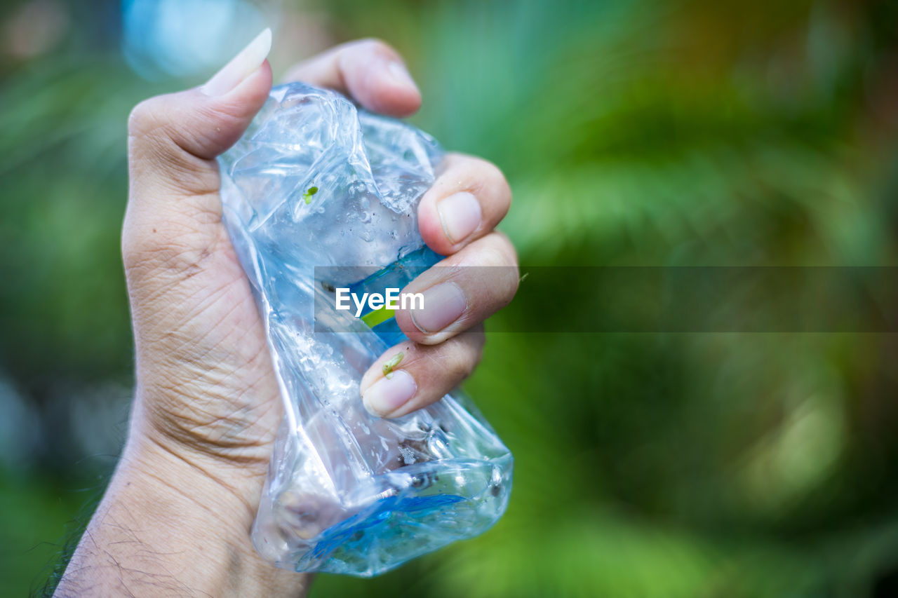 Close-up of hand holding plastic