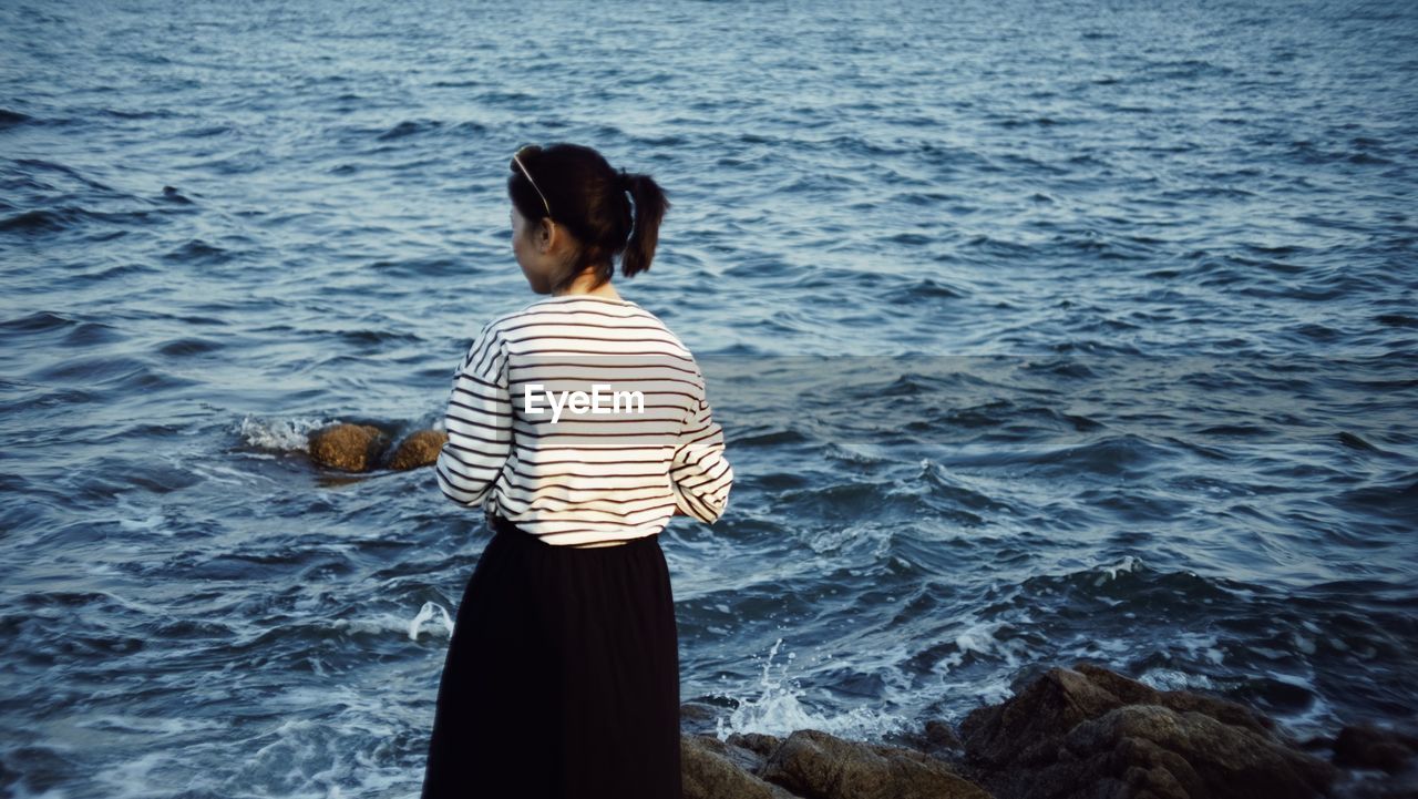 Rear view of woman looking at sea