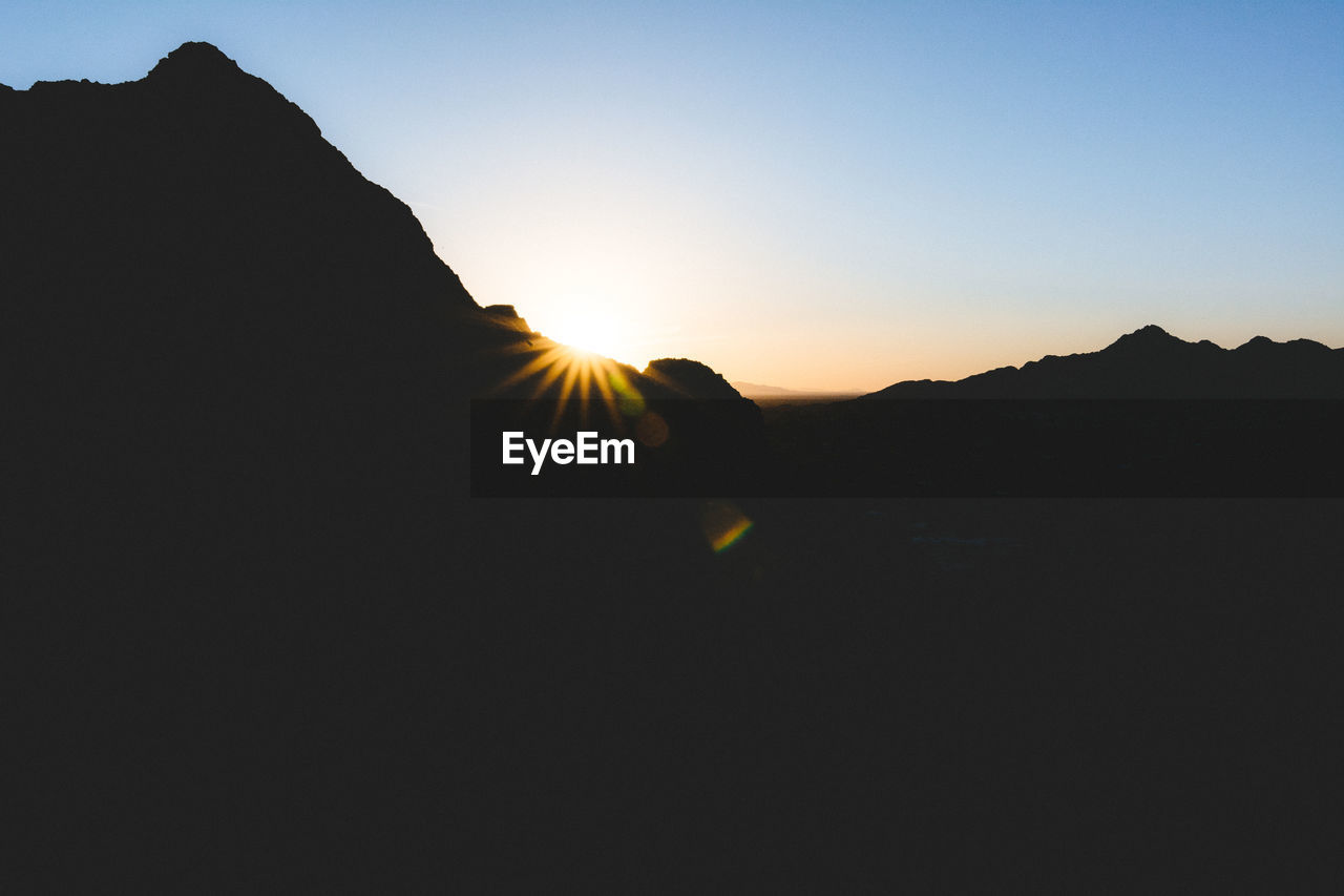 Scenic view of silhouette mountain against sky