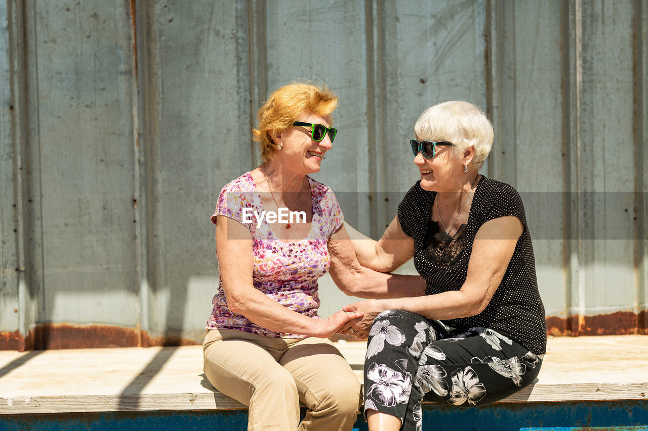 Two elderly women are happy to meet each other