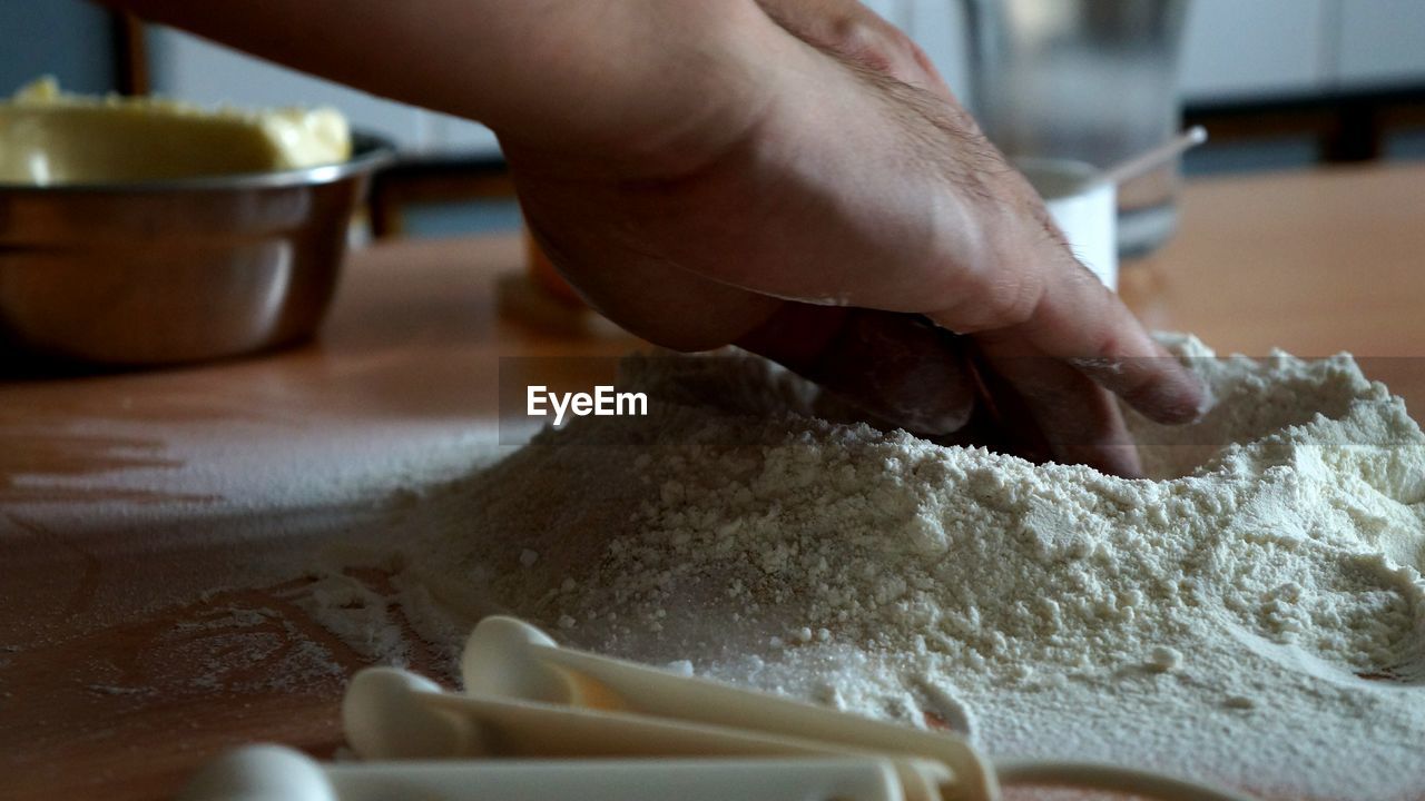 Cropped image of person preparing dough