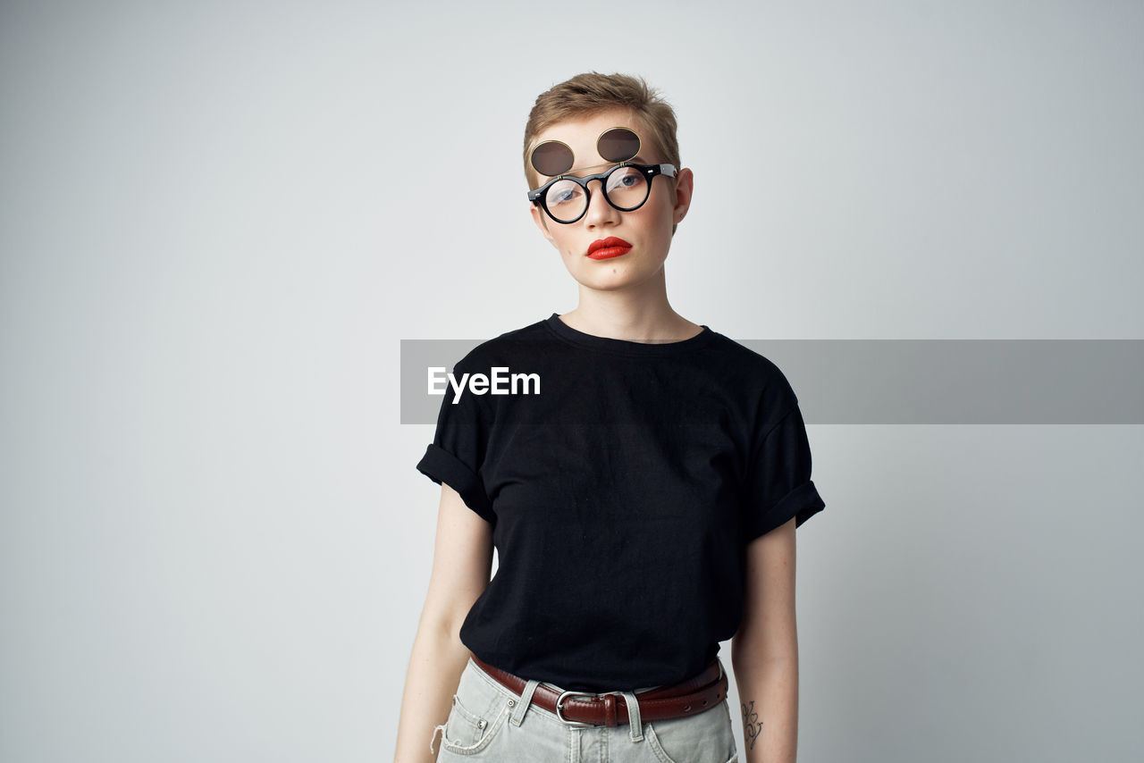 Portrait of teenage girl standing against white background