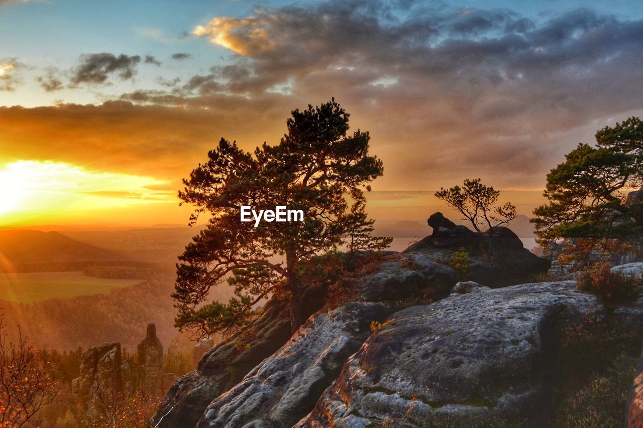 Scenic view of rock against sky during sunset