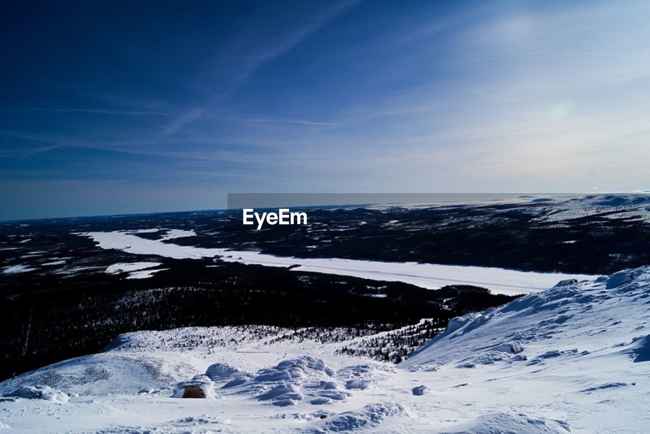 SNOW COVERED MOUNTAIN AGAINST BLUE SKY