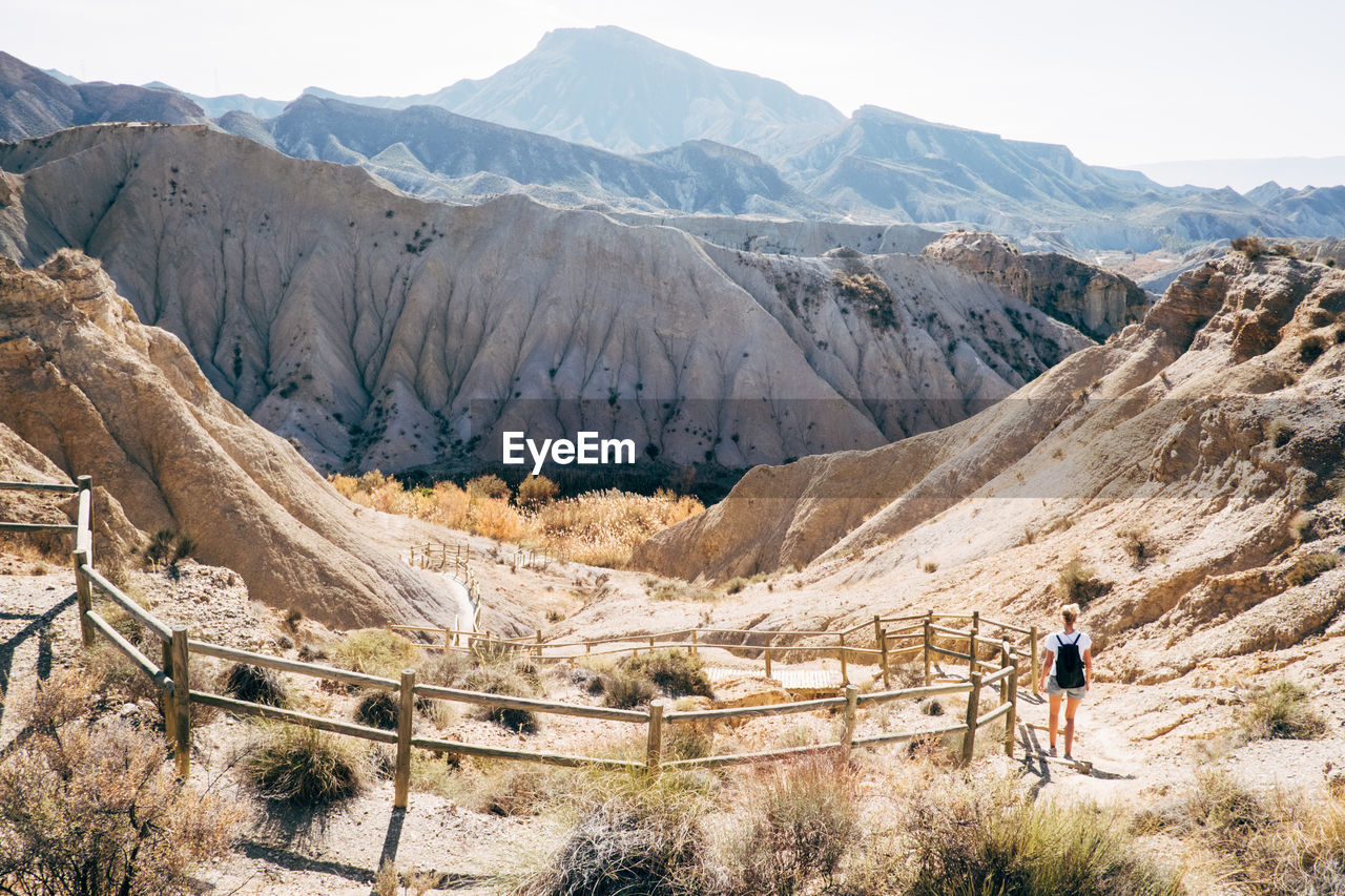 Woman walking on mountain