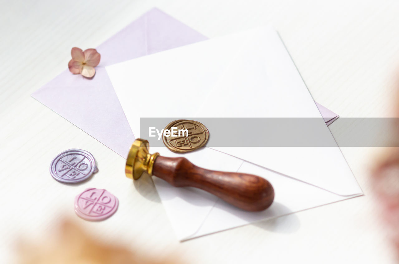 HIGH ANGLE VIEW OF COINS ON PAPER