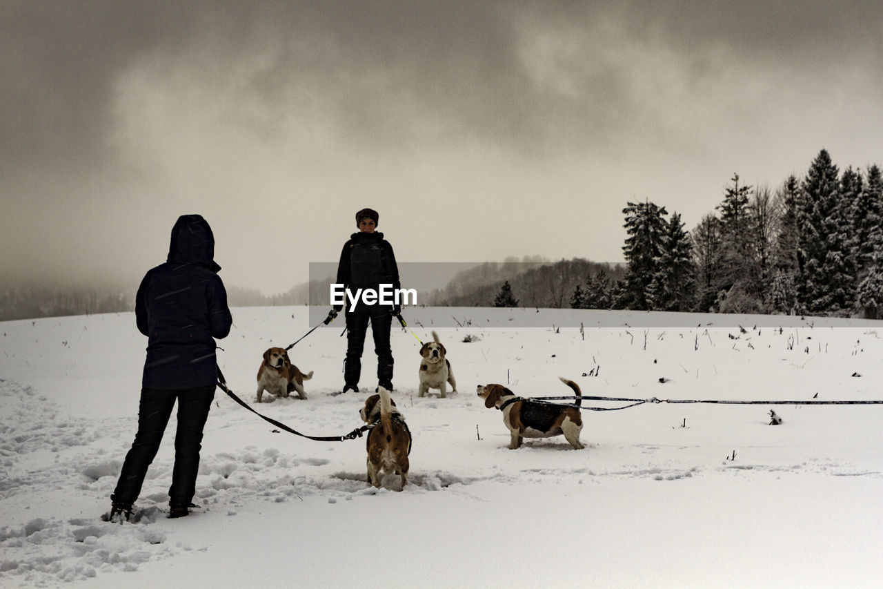 PEOPLE ON SNOW COVERED FIELD