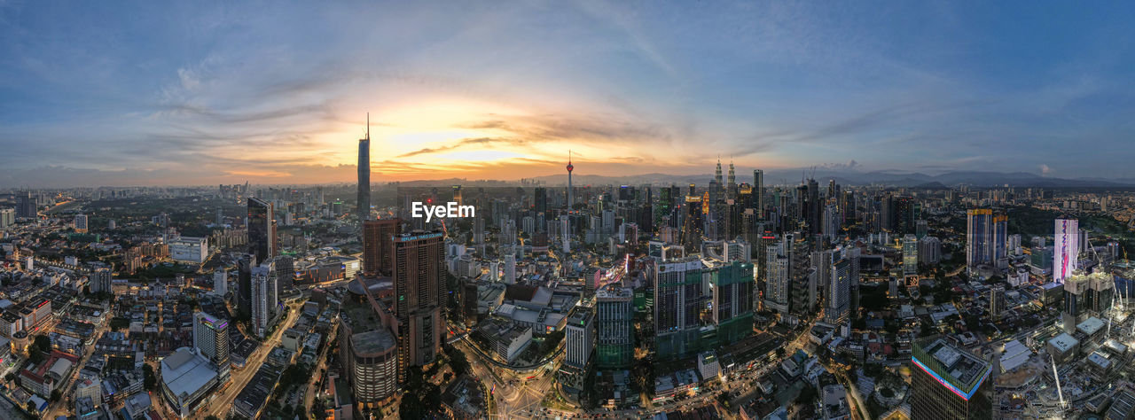 aerial view of cityscape against sky at sunset