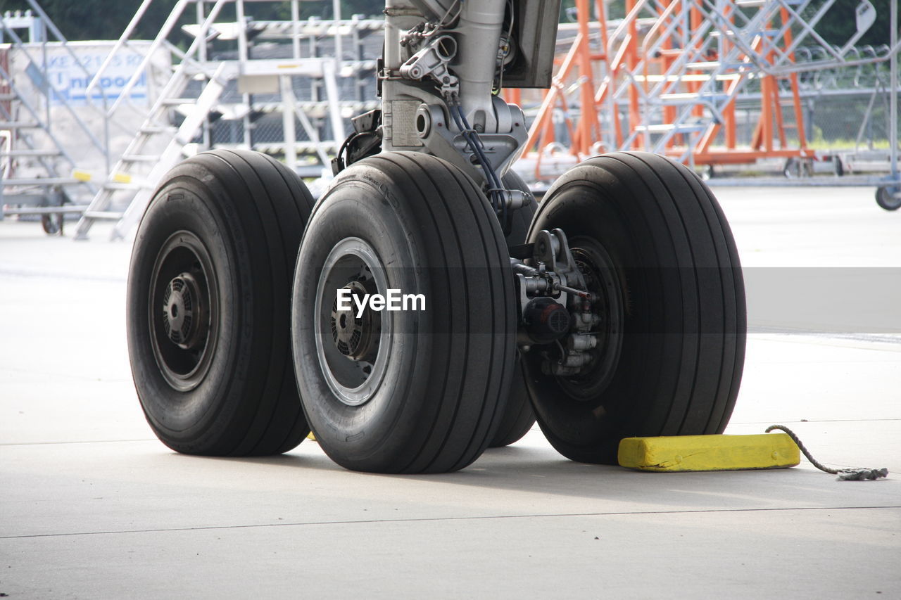 Close-up of airplane tires at runway