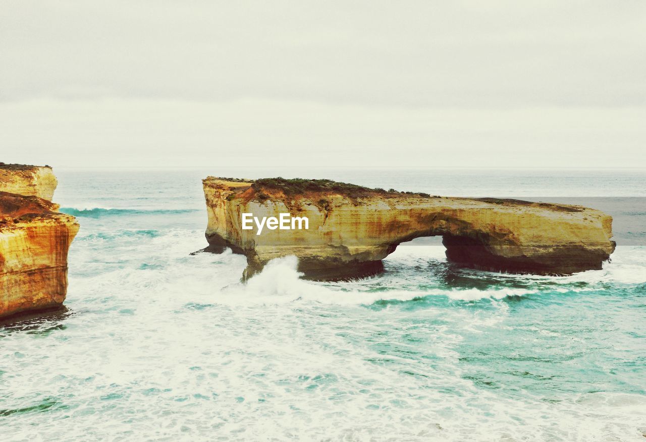 Rock formation in sea against sky at port campbell