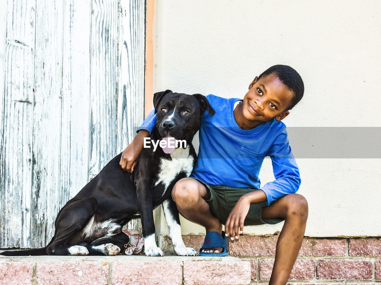 Boy with dog looking away