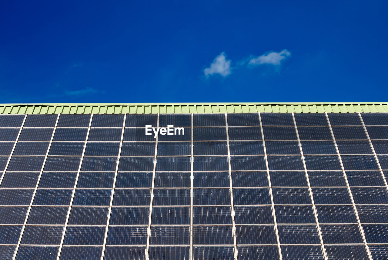 Low angle view of solar panels against sky