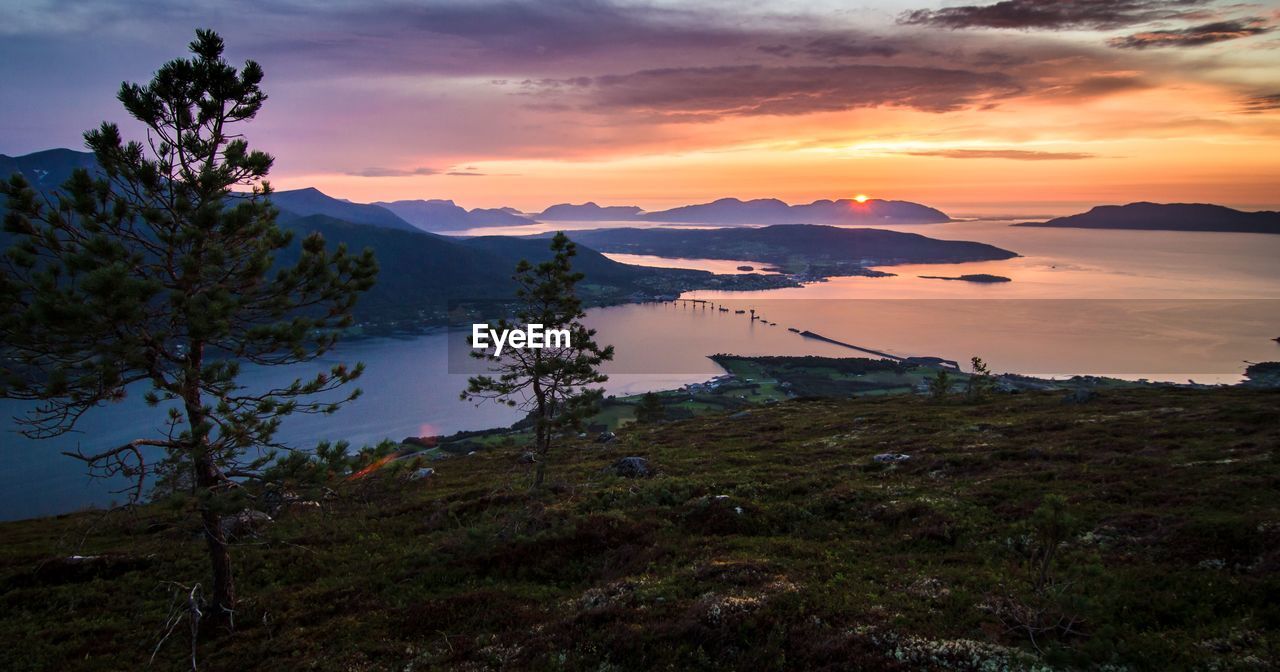 Scenic view of river against sky during sunset