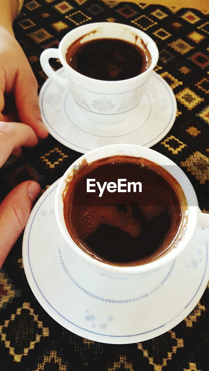 CLOSE-UP OF COFFEE CUP ON TABLE