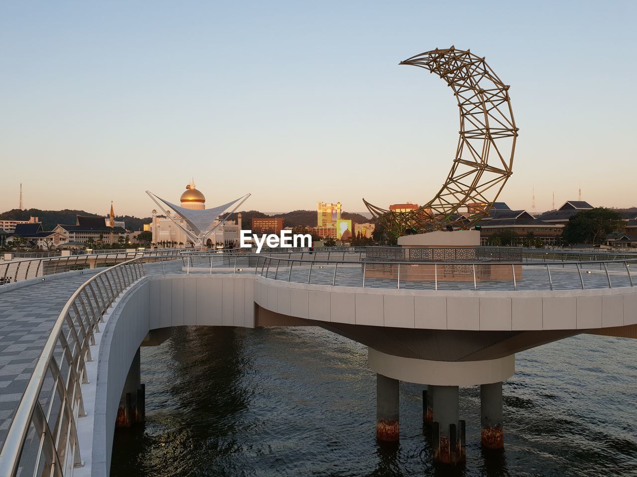 Bridge over river in city at sunset in brunei