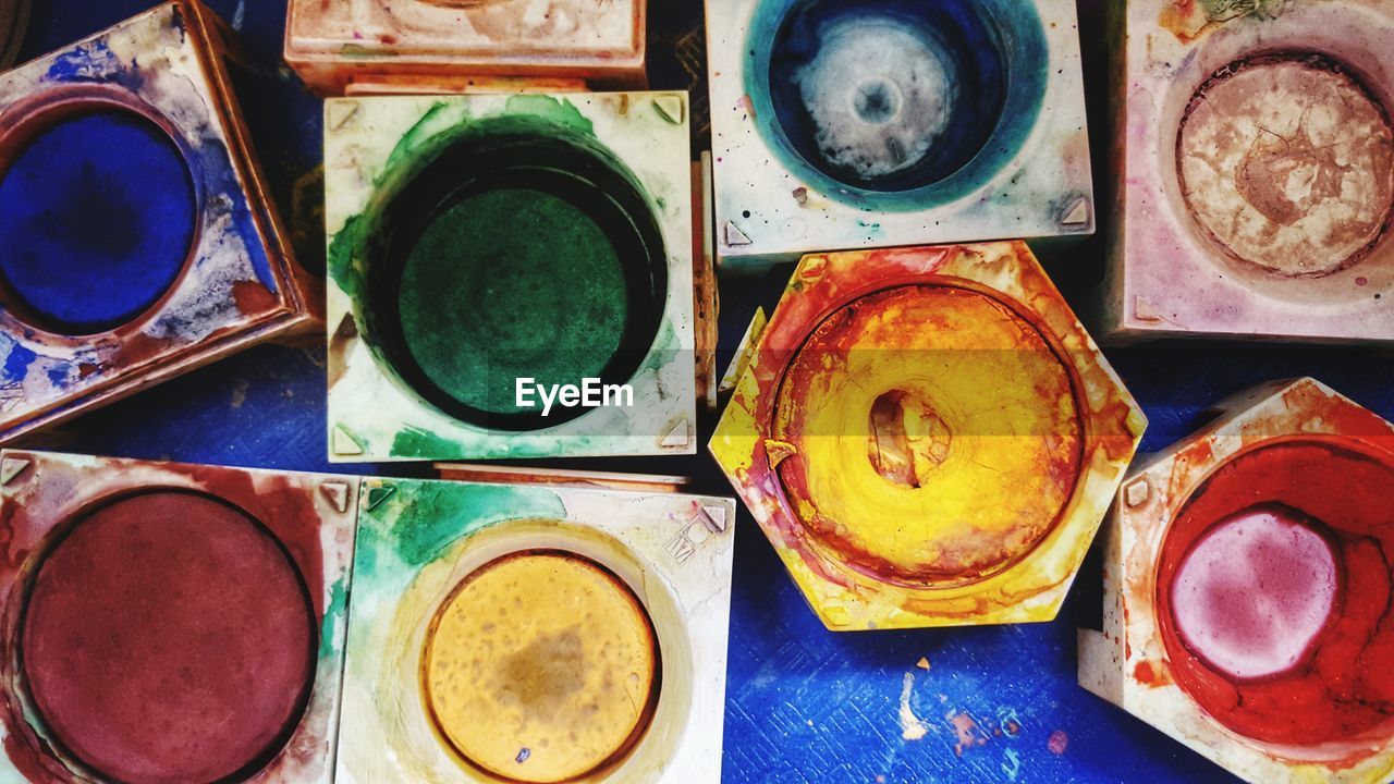 Directly above shot of various watercolor paints on table