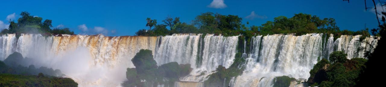 Panoramic view of waterfall against sky