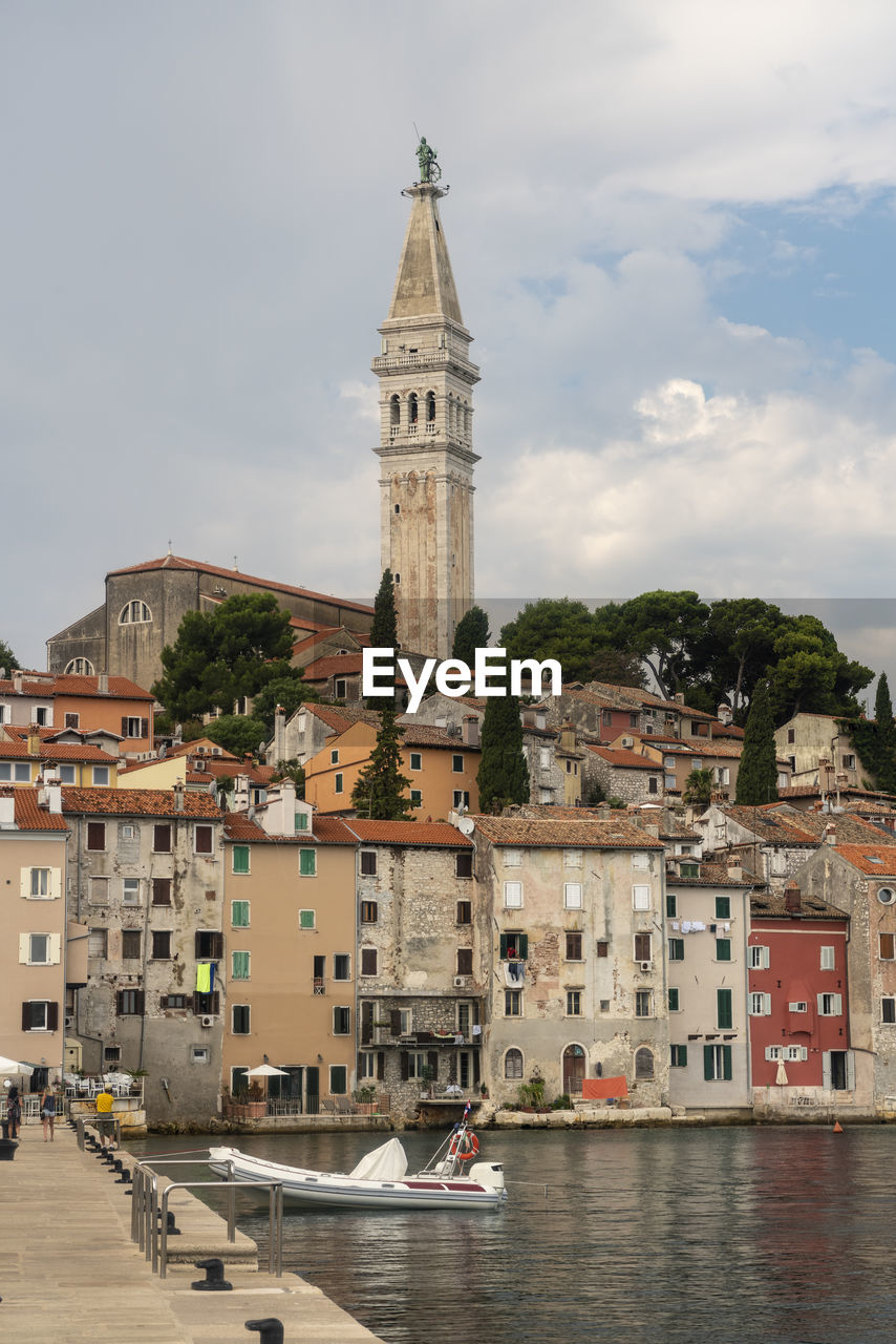 Croatia, istria county, rovinj, harbor of coastal city in summer with tall bell tower of church of saint euphemia in background