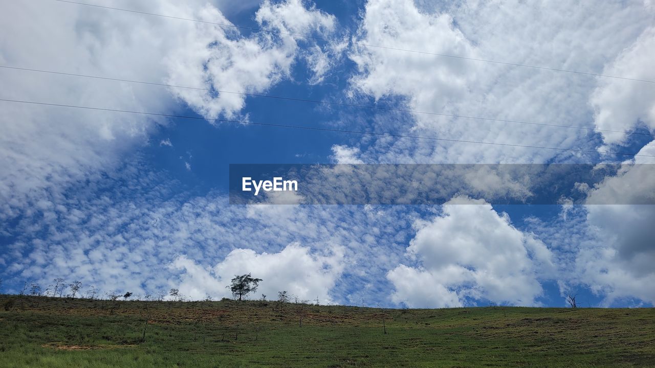 sky, cloud, environment, landscape, horizon, nature, grassland, beauty in nature, scenics - nature, grass, land, plain, plant, field, prairie, blue, no people, tranquility, tranquil scene, day, mountain, non-urban scene, meadow, outdoors, rural scene, cloudscape, rural area, idyllic, tree, green, plateau, agriculture