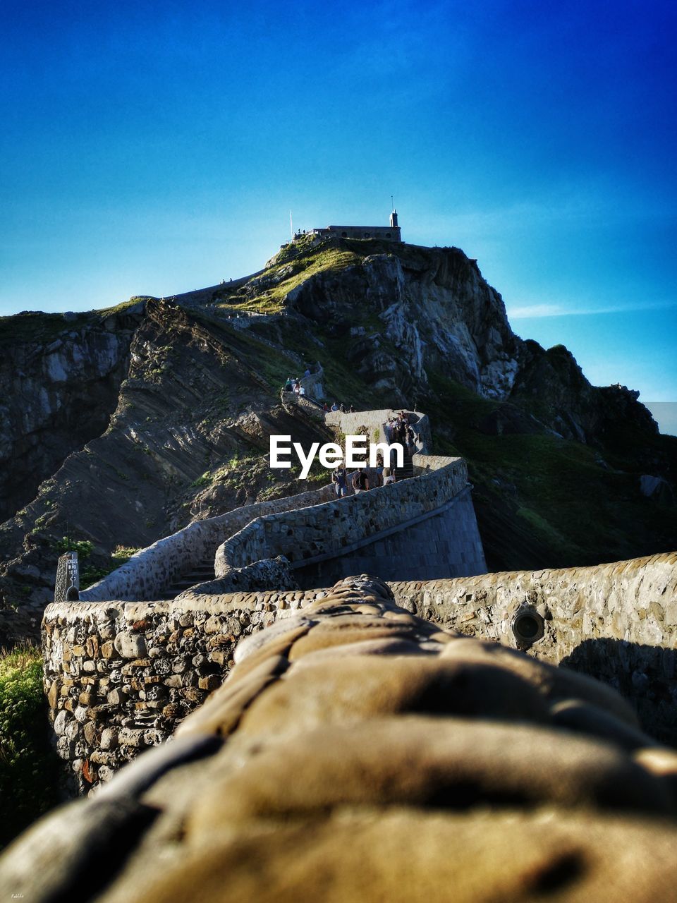 Scenic view of mountains against clear blue sky