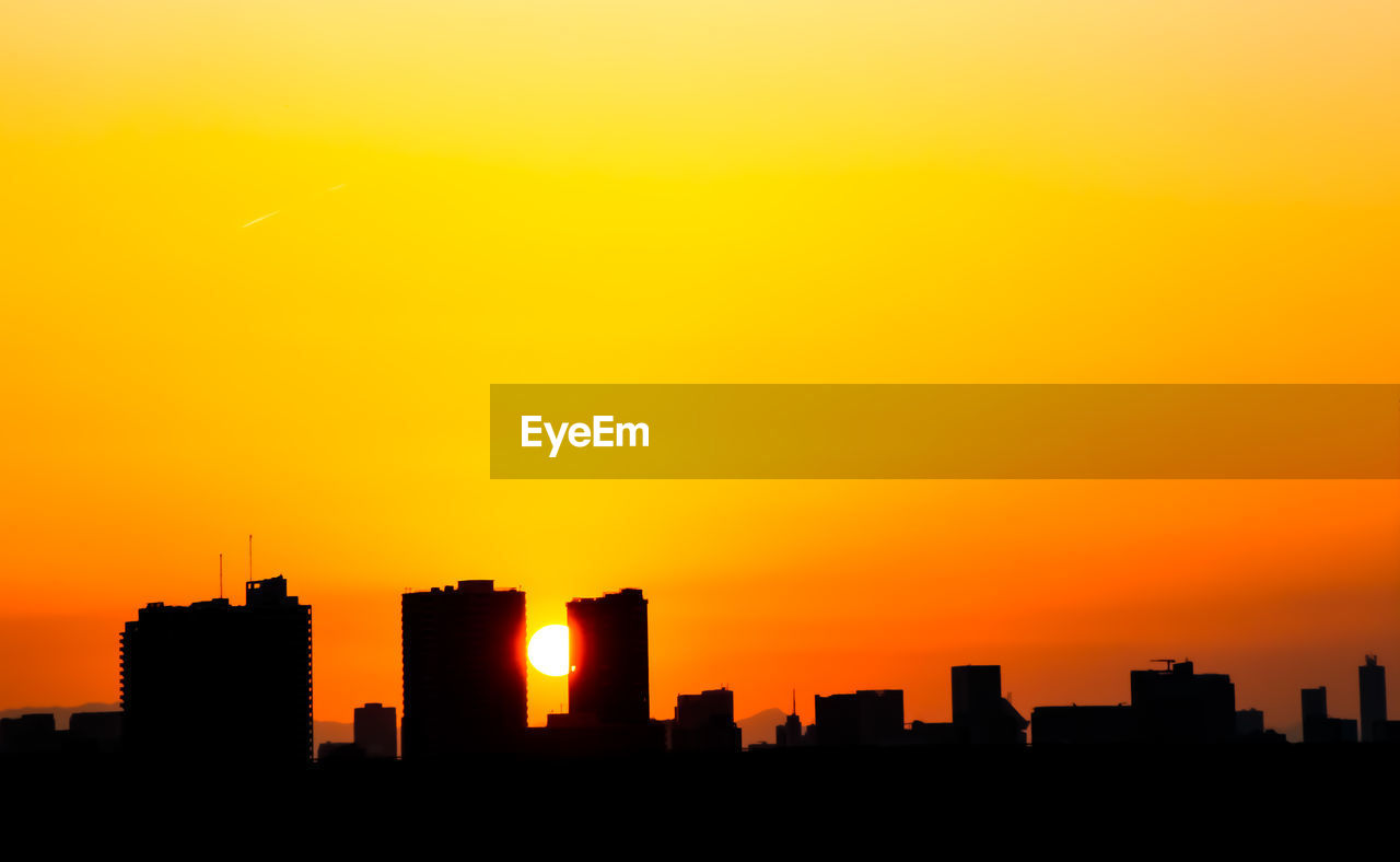 horizon, skyline, sunset, sky, architecture, building exterior, city, afterglow, built structure, urban skyline, cityscape, dawn, silhouette, building, skyscraper, office building exterior, landscape, orange color, nature, city life, no people, residential district, red sky at morning, travel destinations, outdoors, dramatic sky, evening, cloud, sunlight, copy space, yellow, sun, beauty in nature, downtown district