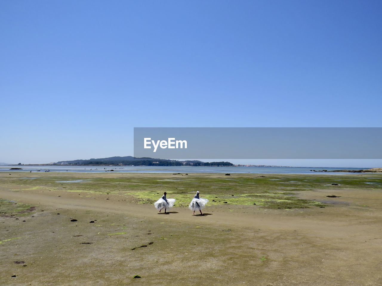 PEOPLE SITTING ON BEACH