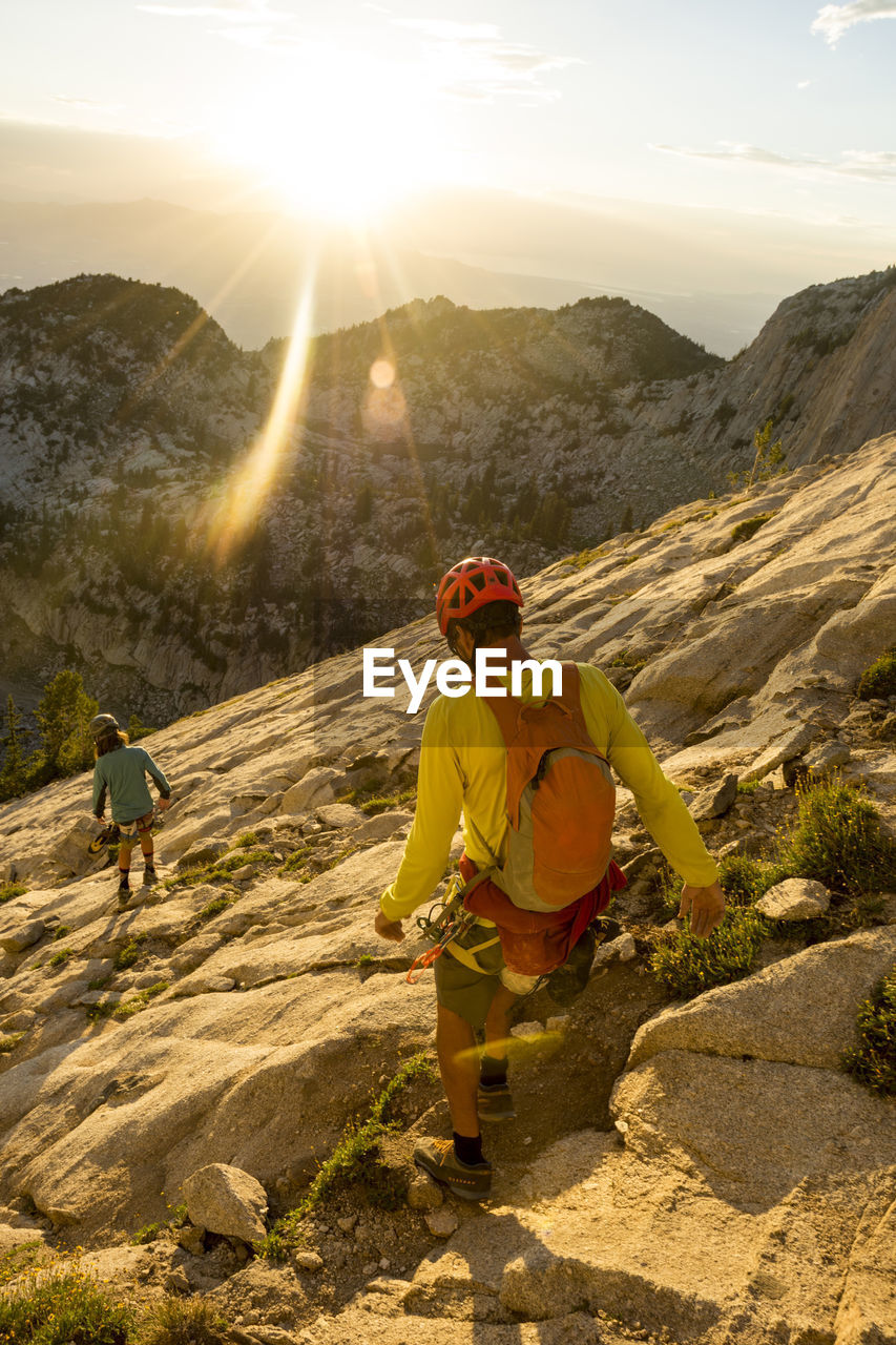 A father and son descending from lone peak, utah