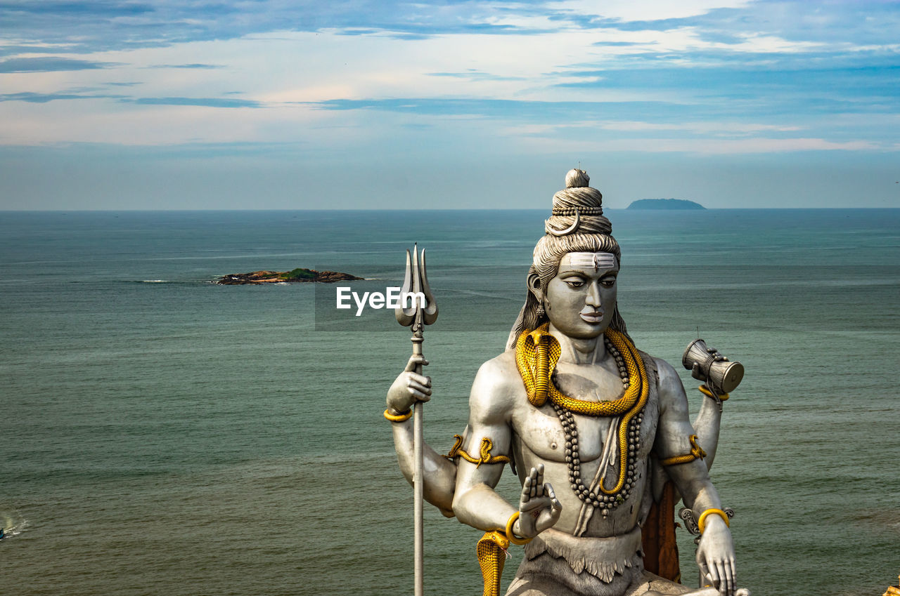 Shiva statue isolated at murdeshwar temple aerial shots with arabian sea in the backdrop