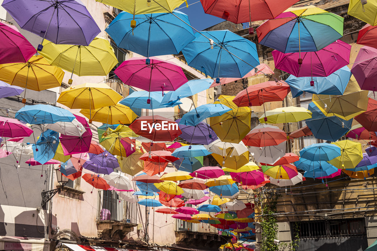 protection, umbrella, multi colored, large group of objects, hanging, security, tradition, architecture, fashion accessory, abundance, no people, day, low angle view, market, outdoors, variation, in a row, nature, parasol, lantern, built structure, decoration, city, repetition, sky, celebration, building exterior, retail