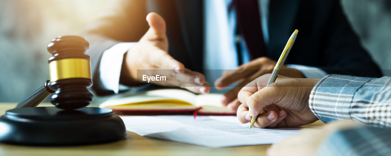 adult, hand, indoors, men, writing, conversation, education, table, business, selective focus, learning, sitting, pen, student, occupation, desk, furniture, planning, one person, working, document, businessman, close-up, cooperation, person, paper, office, studying, holding