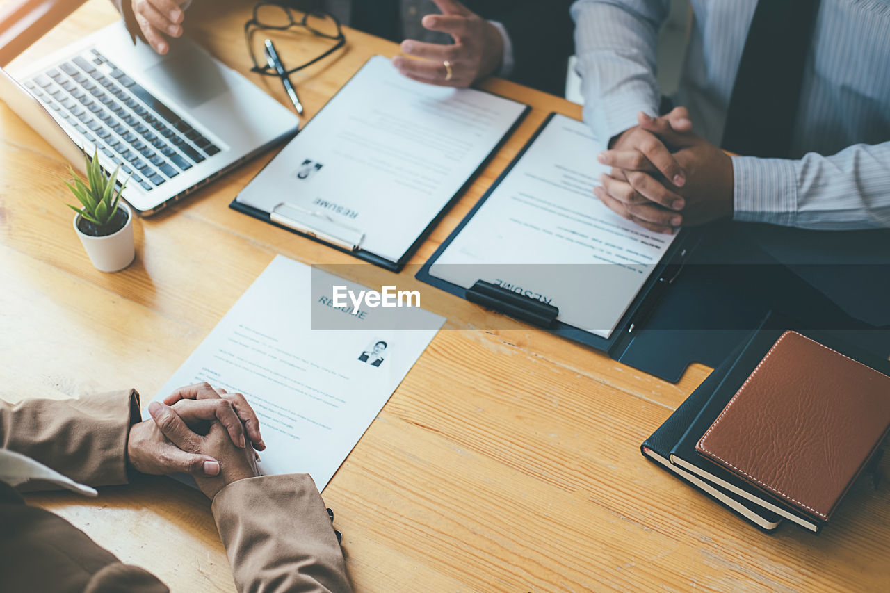 Business people taking job interview at desk in office