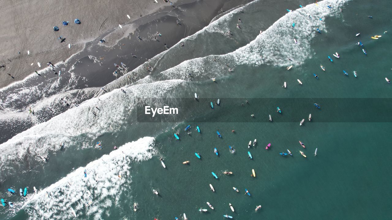 High angle view of people on sea shore during winter