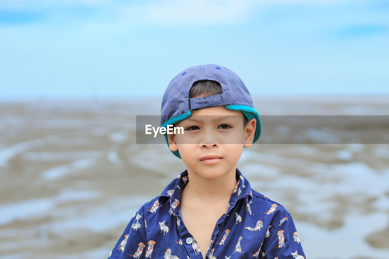 Boy standing at beach