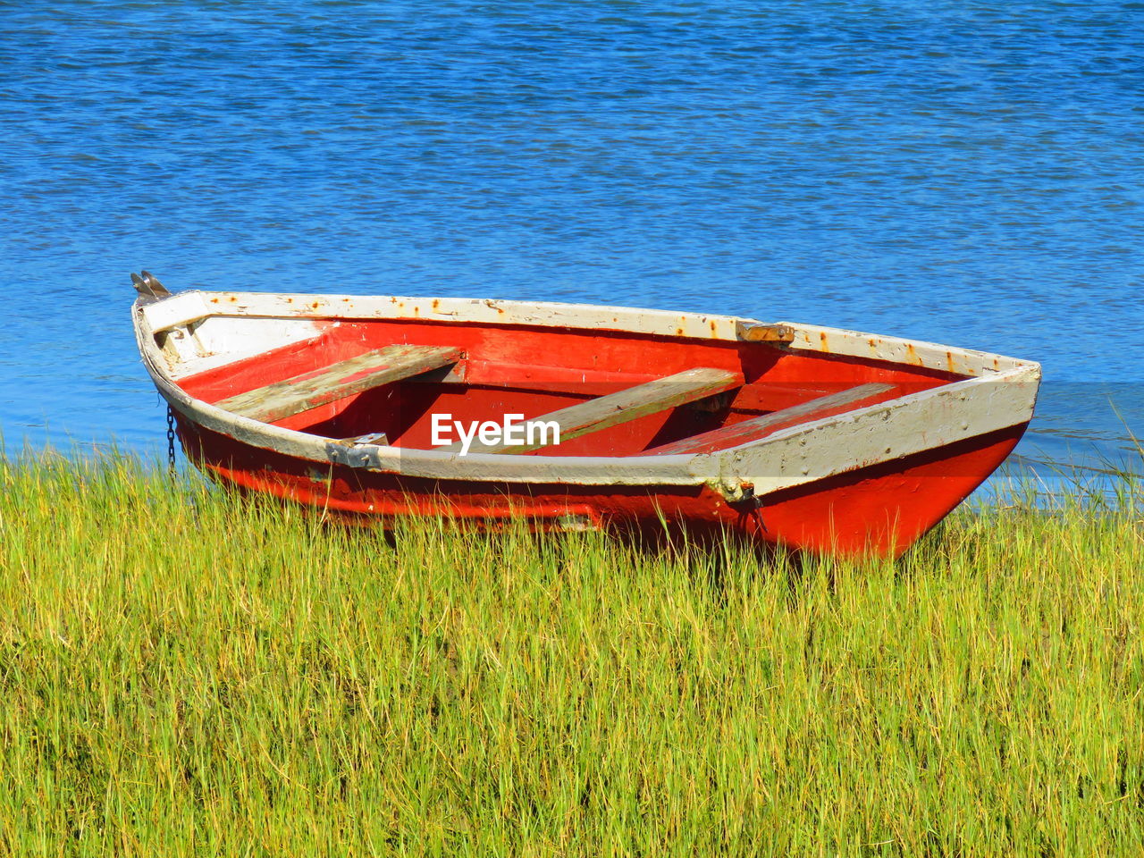 ABANDONED BOAT MOORED ON SHORE