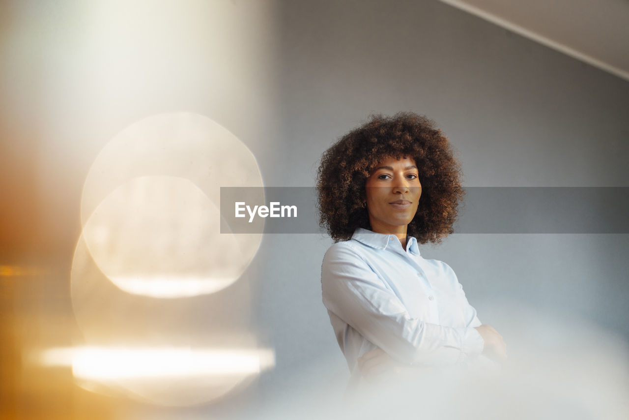 Businesswoman with arms crossed in office