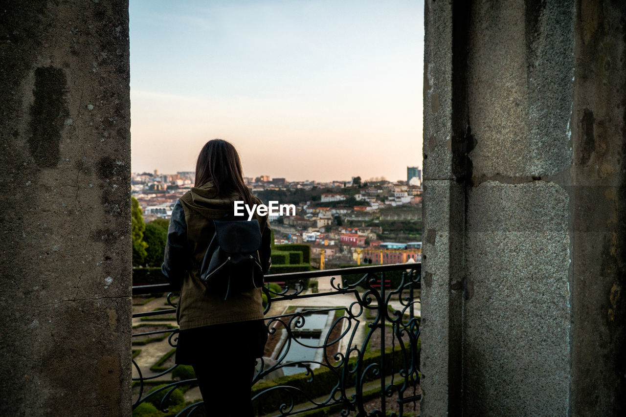 Rear view of woman looking at cityscape