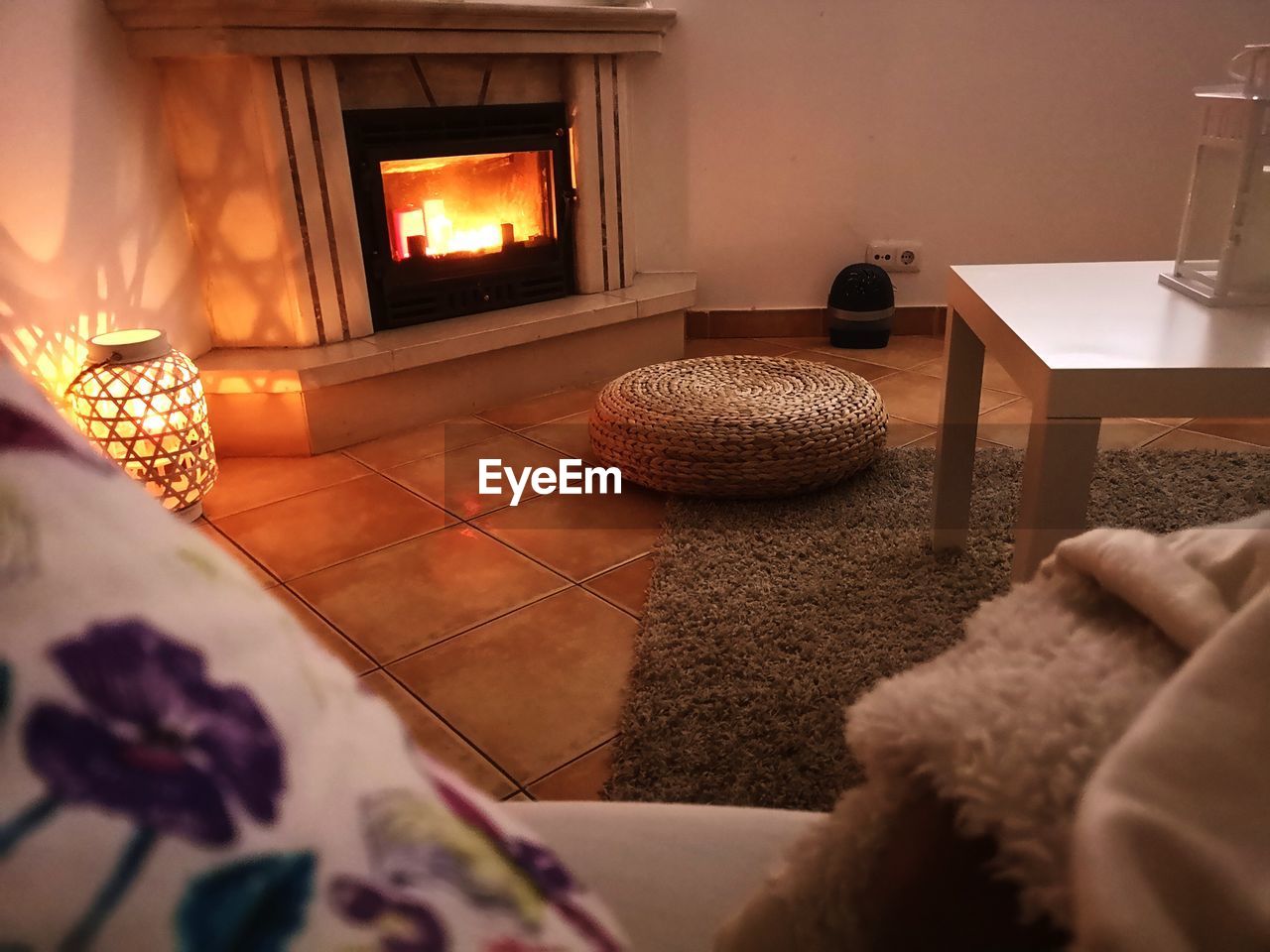 Basket on floor against fireplace at home