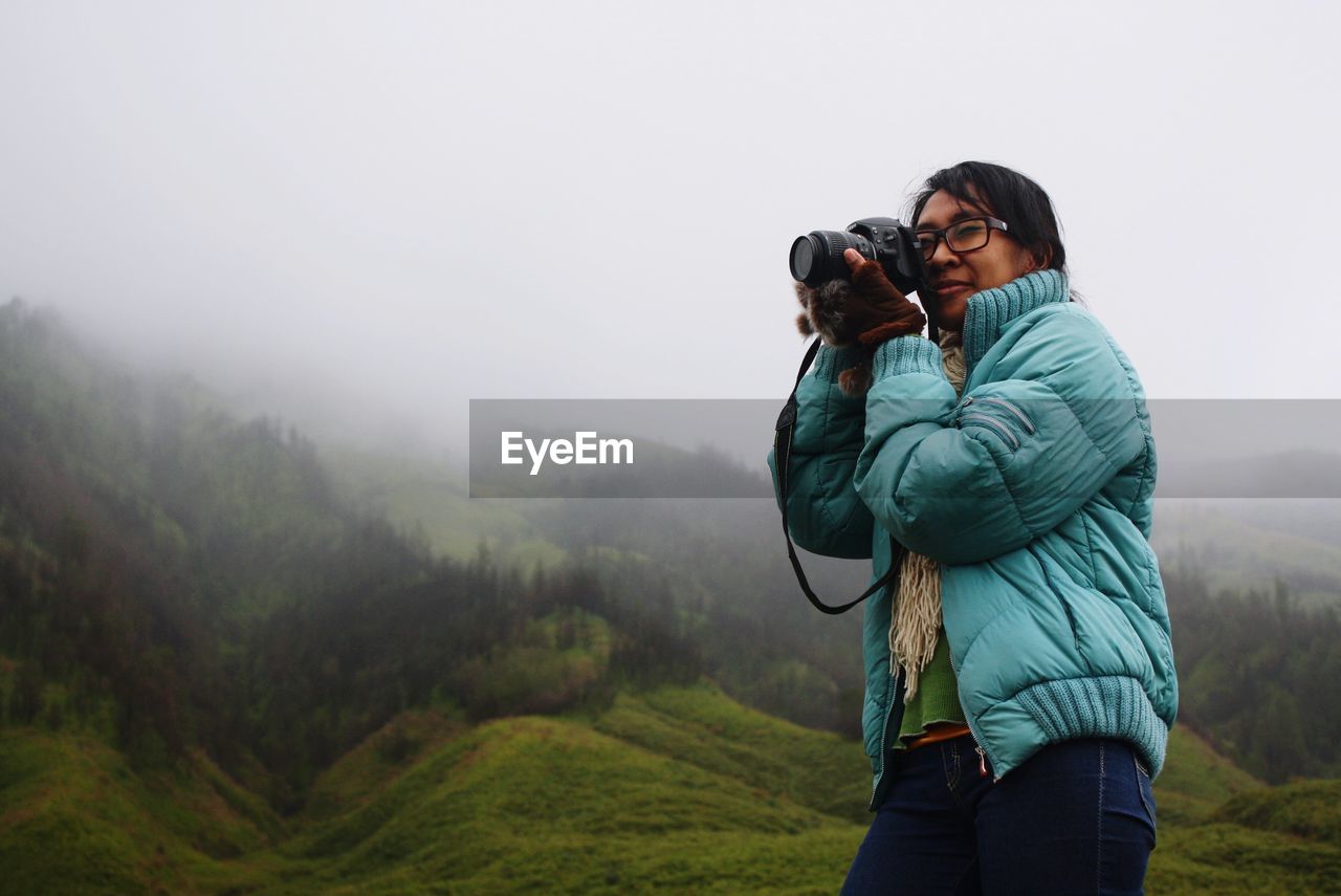 Woman photographing on camera