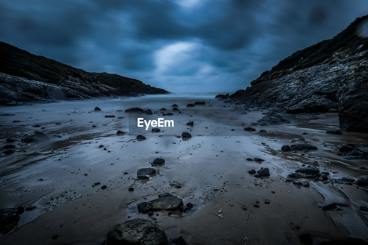 Scenic view of beach against sky during winter