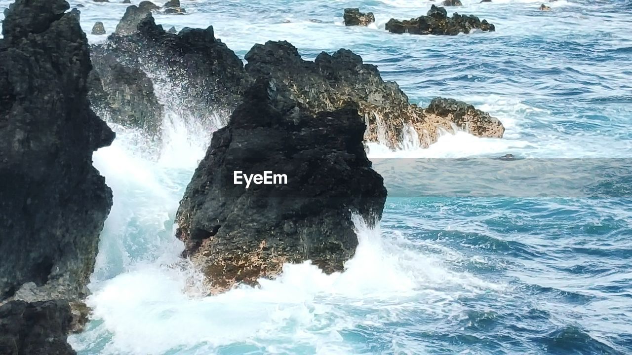 High angle view of rocks in sea