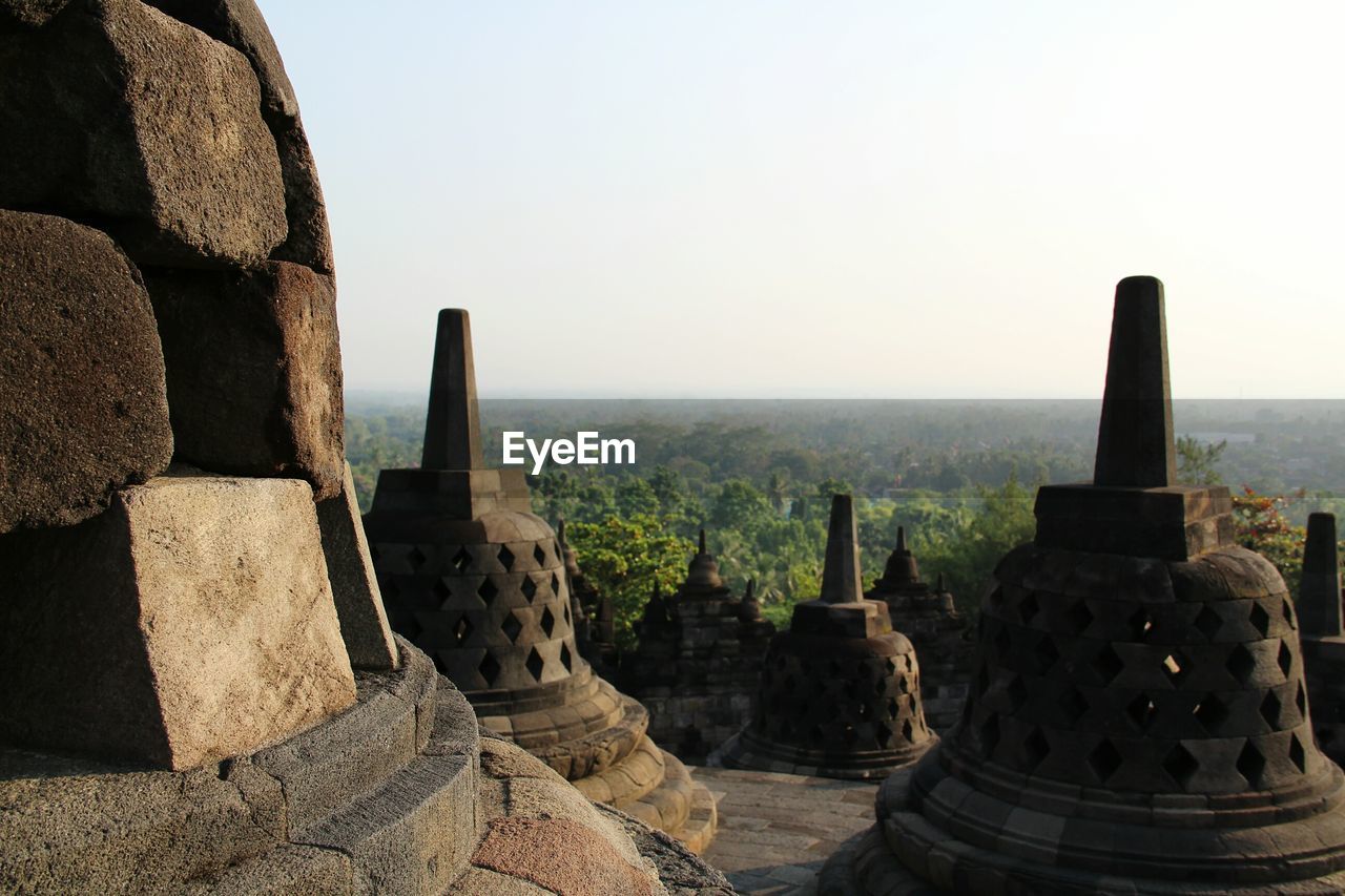 Stupas at temple against sky