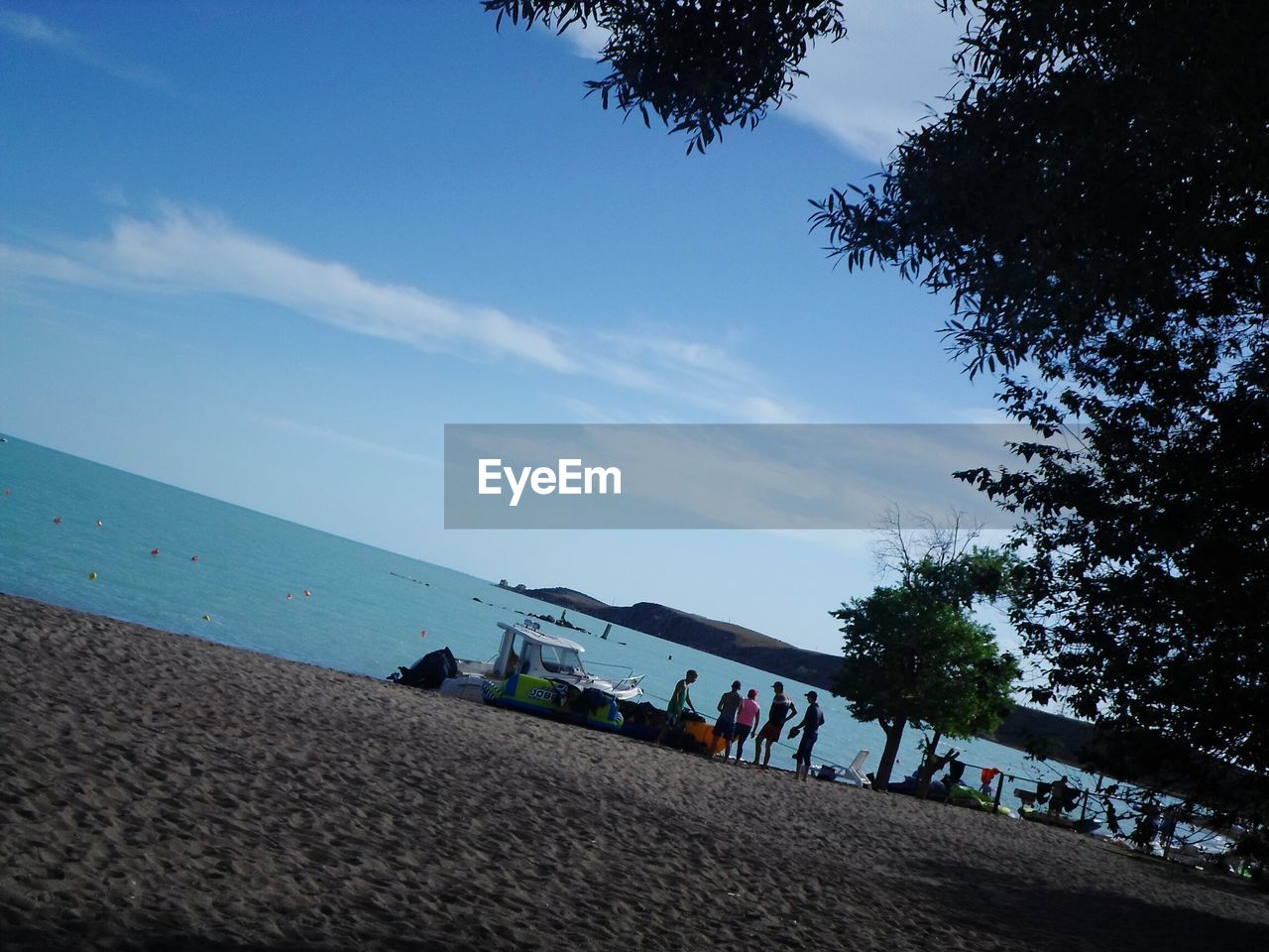 PEOPLE ON BEACH AGAINST SKY