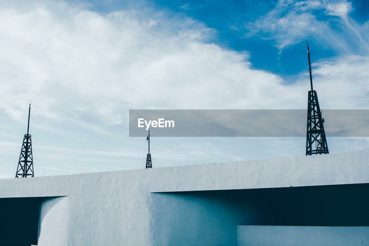 View of communications tower against cloudy sky